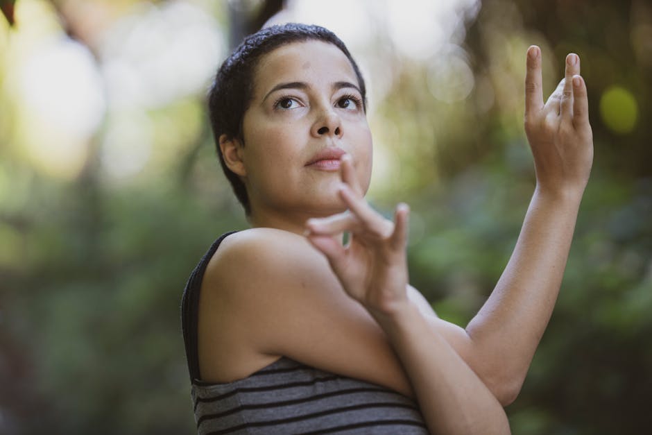 A calm person in a natural yoga pose against a soft purple background.